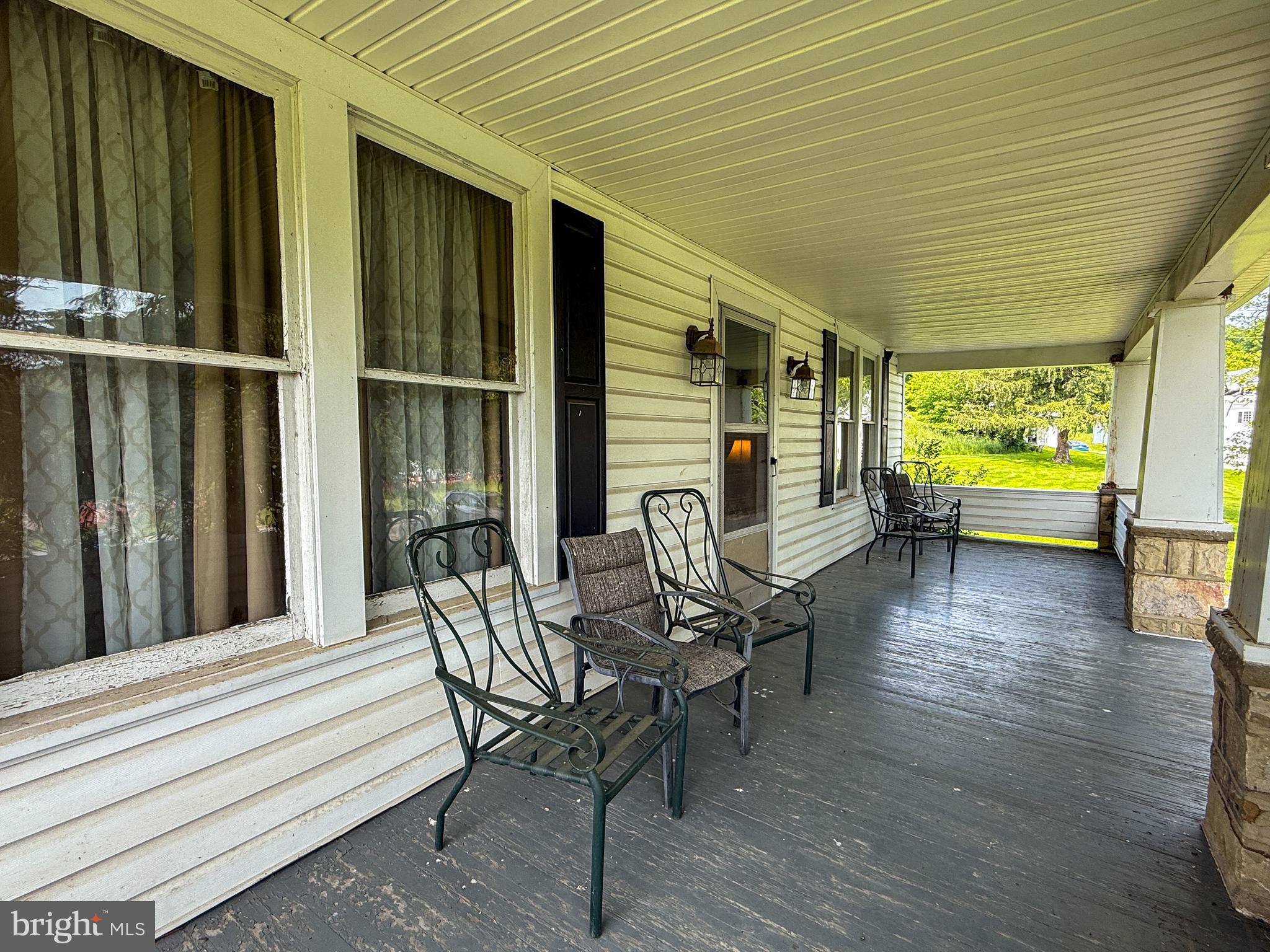 930 Osman Road Alum Bank, PA 15521 - Photo 5 of 63 a view of a patio with table and chairs with wooden floor and fence
