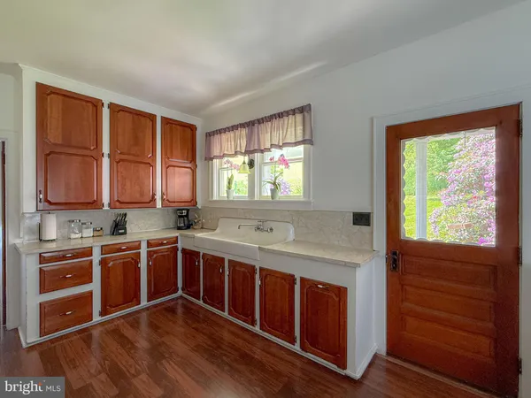 a kitchen with a stove sink and cabinets