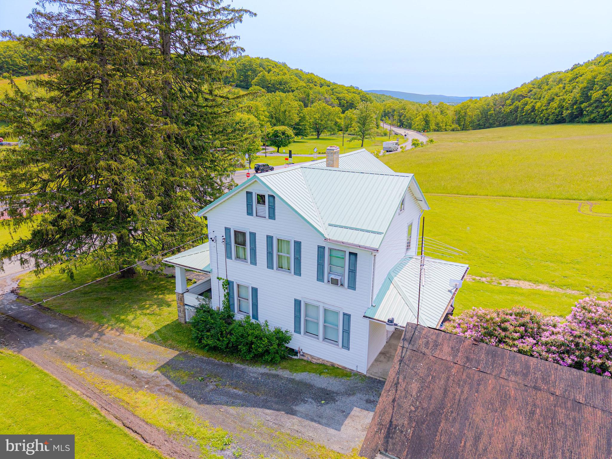 930 Osman Road Alum Bank, PA 15521 - Photo 66 of 66 a aerial view of a house with a garden and lake view