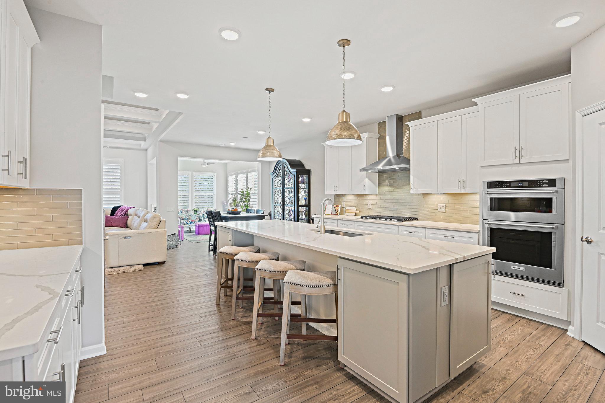 15788 Gardenia Rdg Way Haymarket, VA 20169 - Photo 12 of 50 a kitchen with stainless steel appliances kitchen island granite countertop a stove a kitchen island a sink and a refrigerator