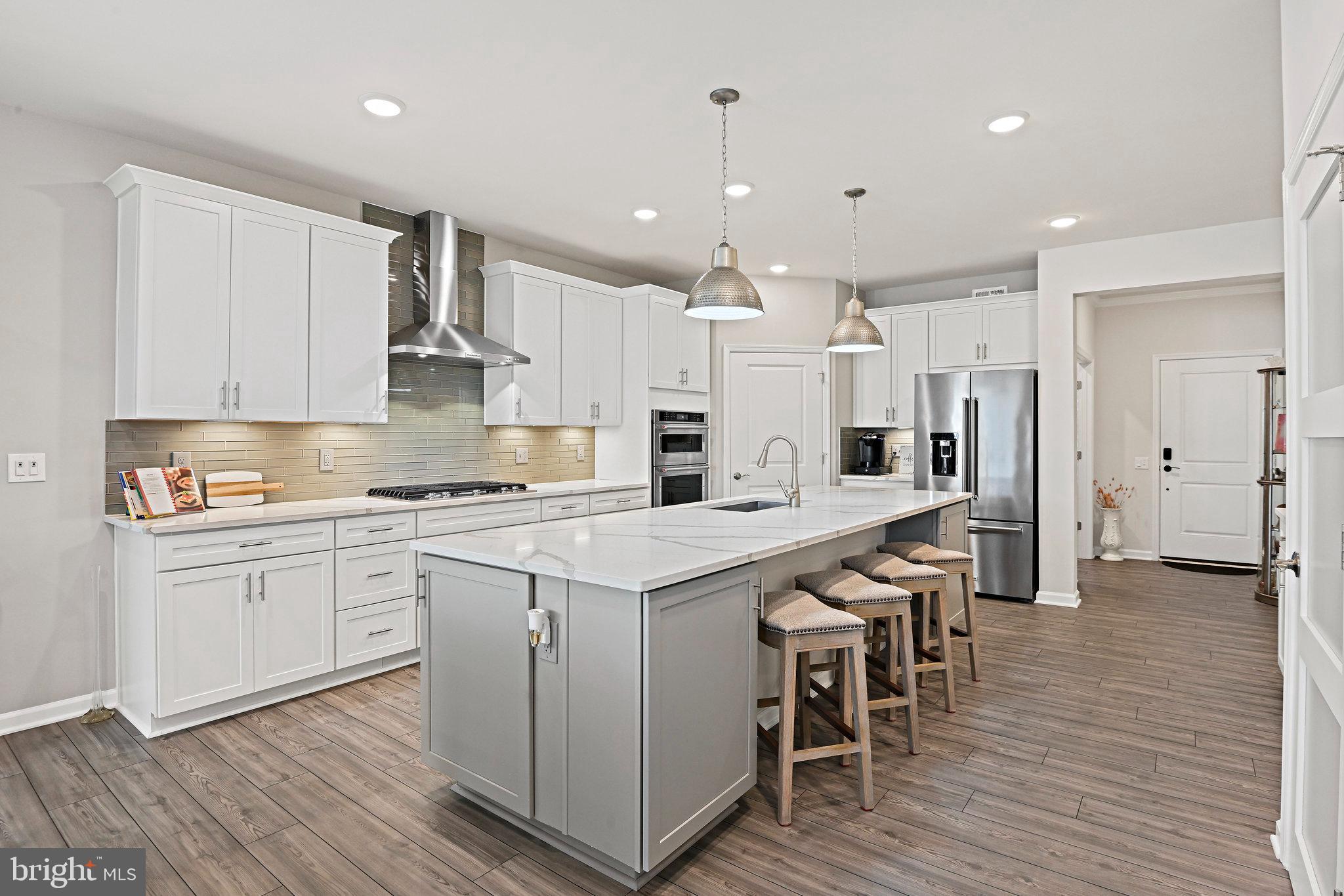 15788 Gardenia Rdg Way Haymarket, VA 20169 - Photo 13 of 50 a large kitchen with cabinets wooden floor and stainless steel appliances