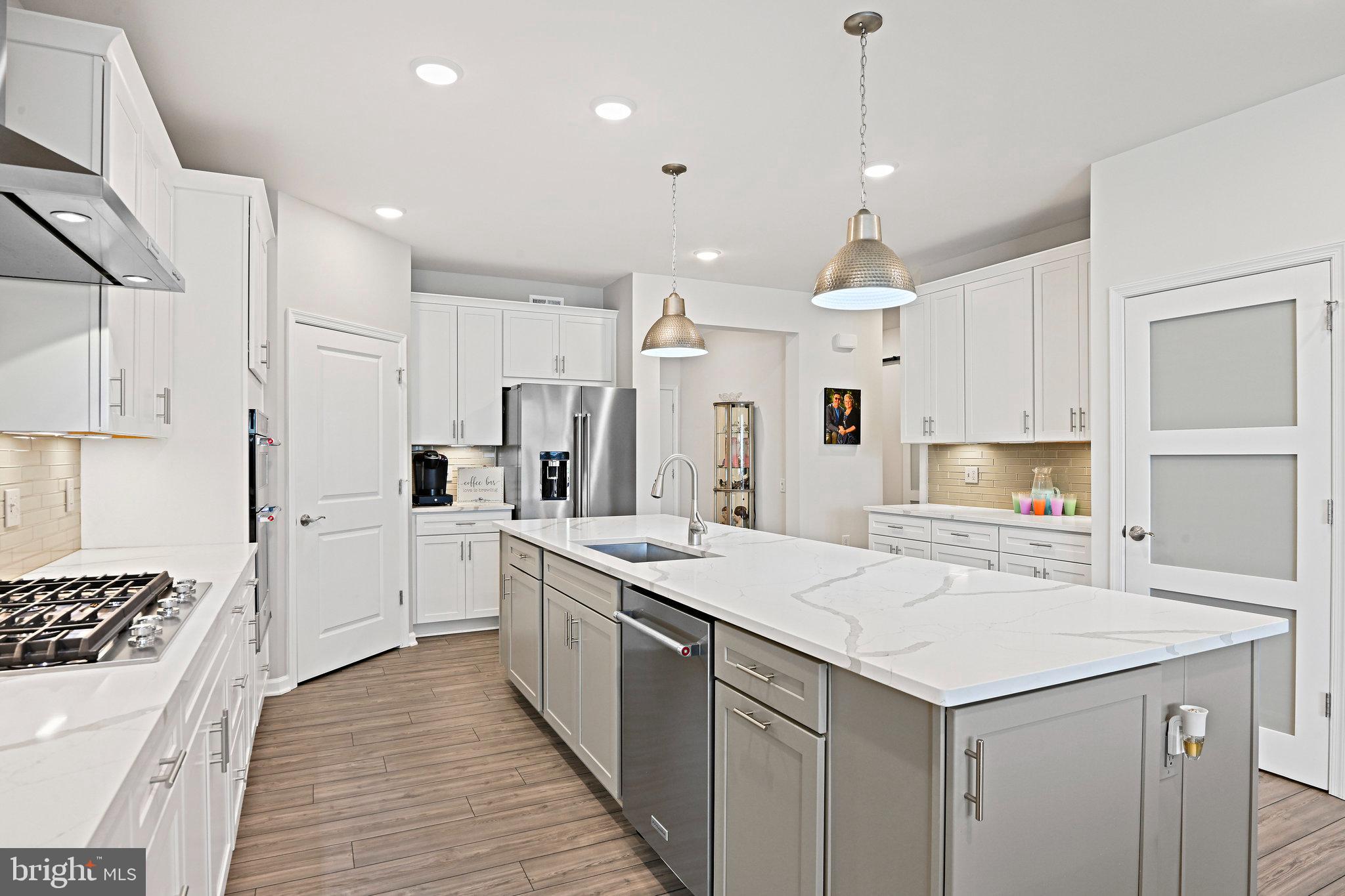 15788 Gardenia Rdg Way Haymarket, VA 20169 - Photo 14 of 50 a large white kitchen with a stove a sink a refrigerator and a refrigerator