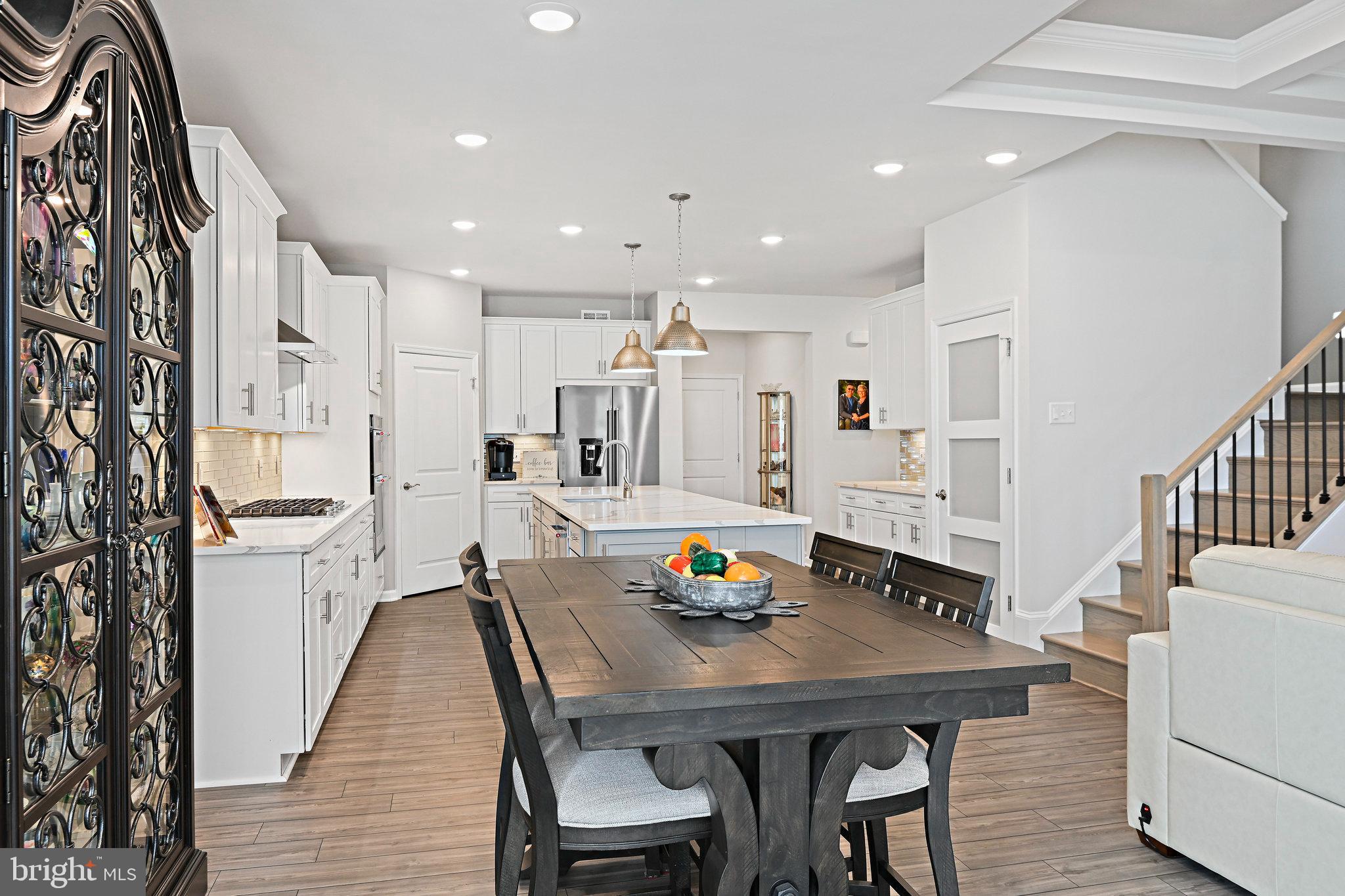15788 Gardenia Rdg Way Haymarket, VA 20169 - Photo 17 of 50 a view of a dining room with furniture and wooden floor
