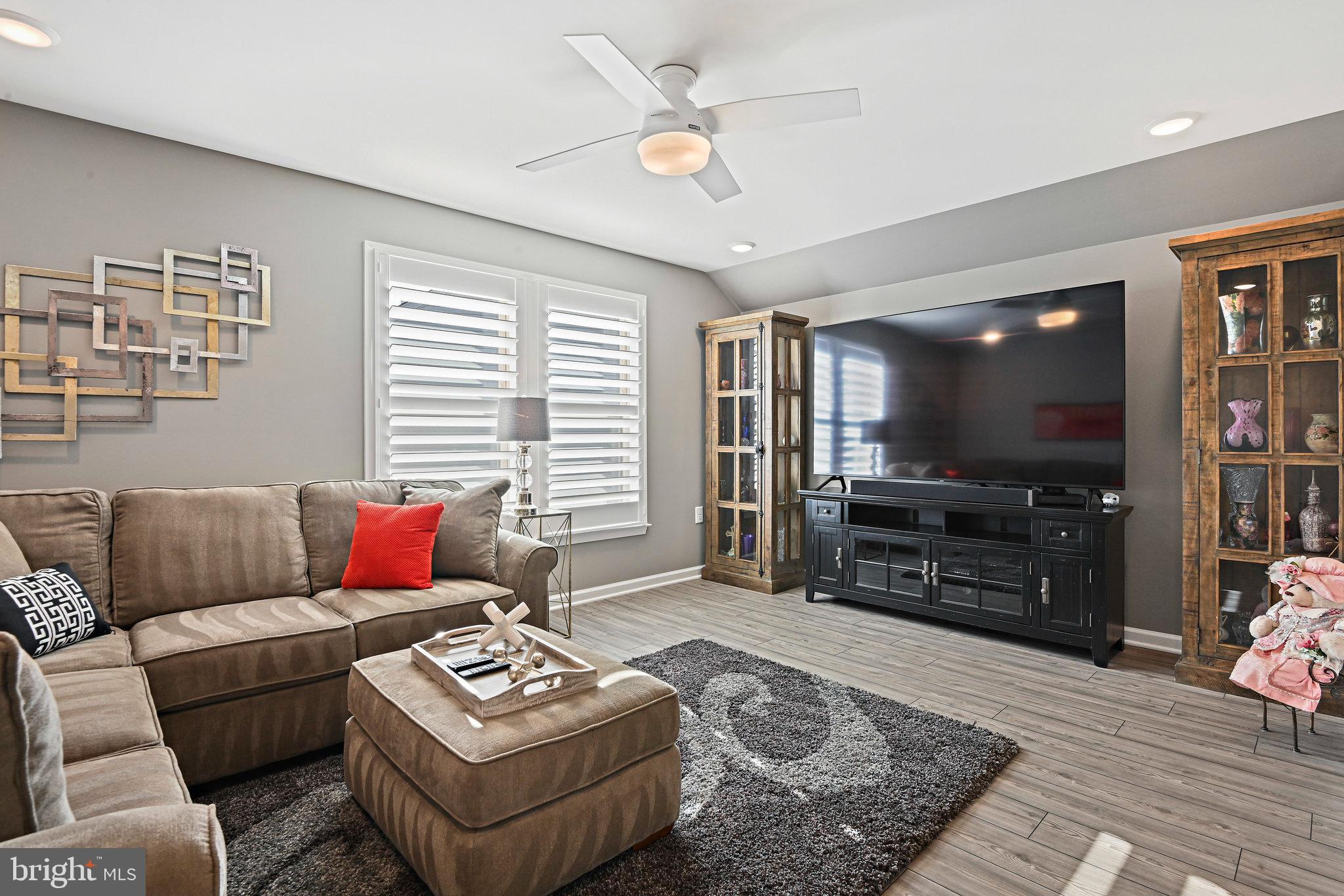 15788 Gardenia Rdg Way Haymarket, VA 20169 - Photo 24 of 50 a living room with furniture and a flat screen tv
