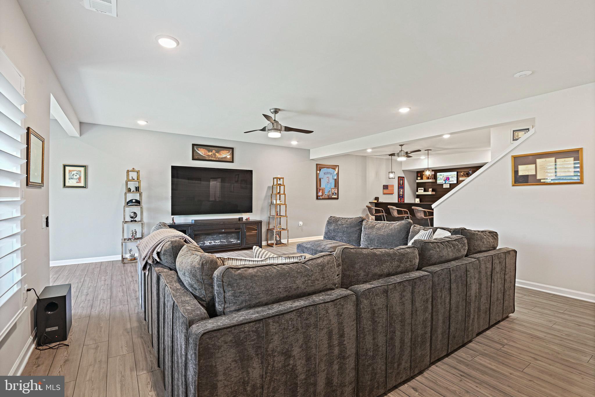 15788 Gardenia Rdg Way Haymarket, VA 20169 - Photo 33 of 50 a living room with furniture and a flat screen tv