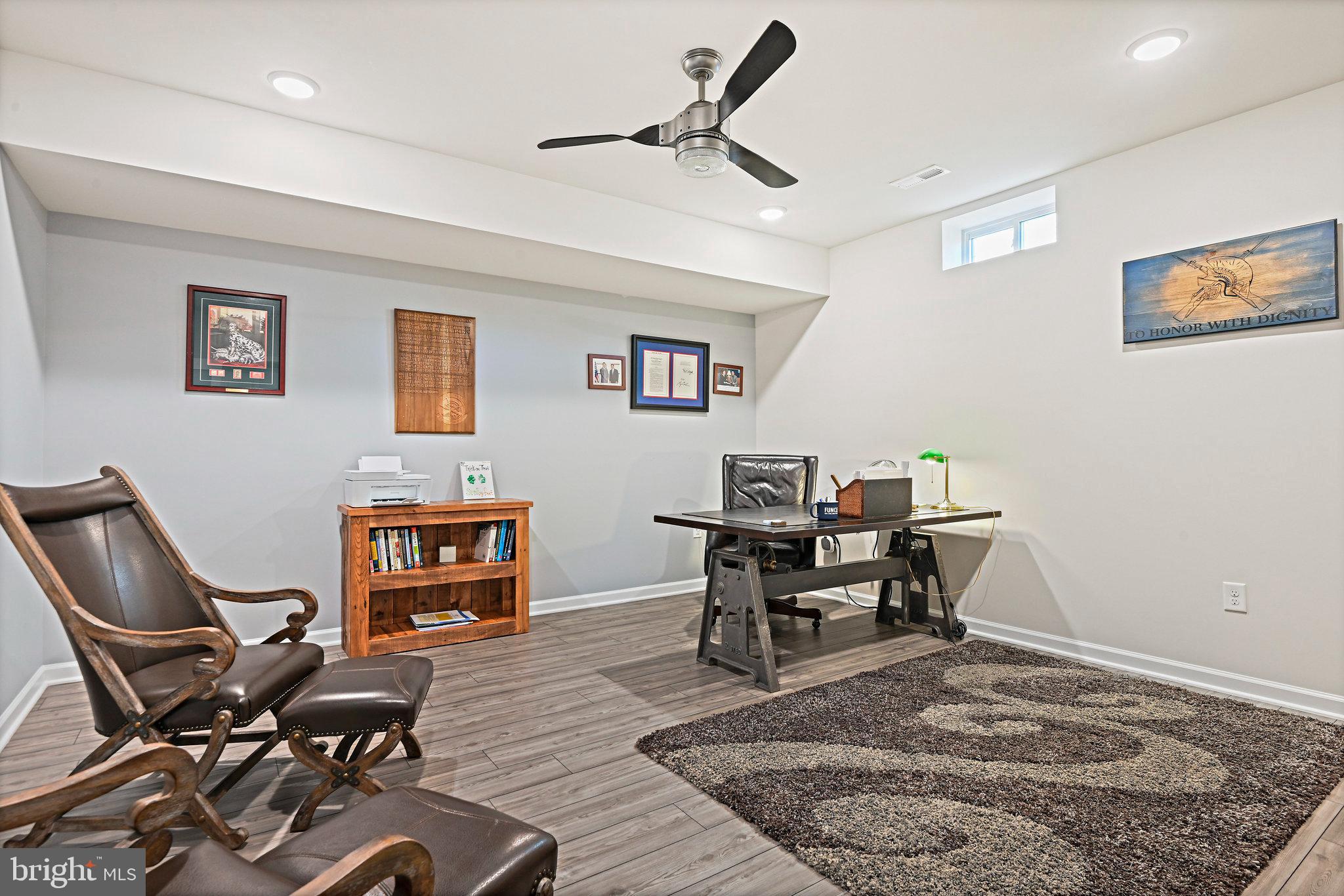 15788 Gardenia Rdg Way Haymarket, VA 20169 - Photo 35 of 50 a work room with furniture and a bookshelf