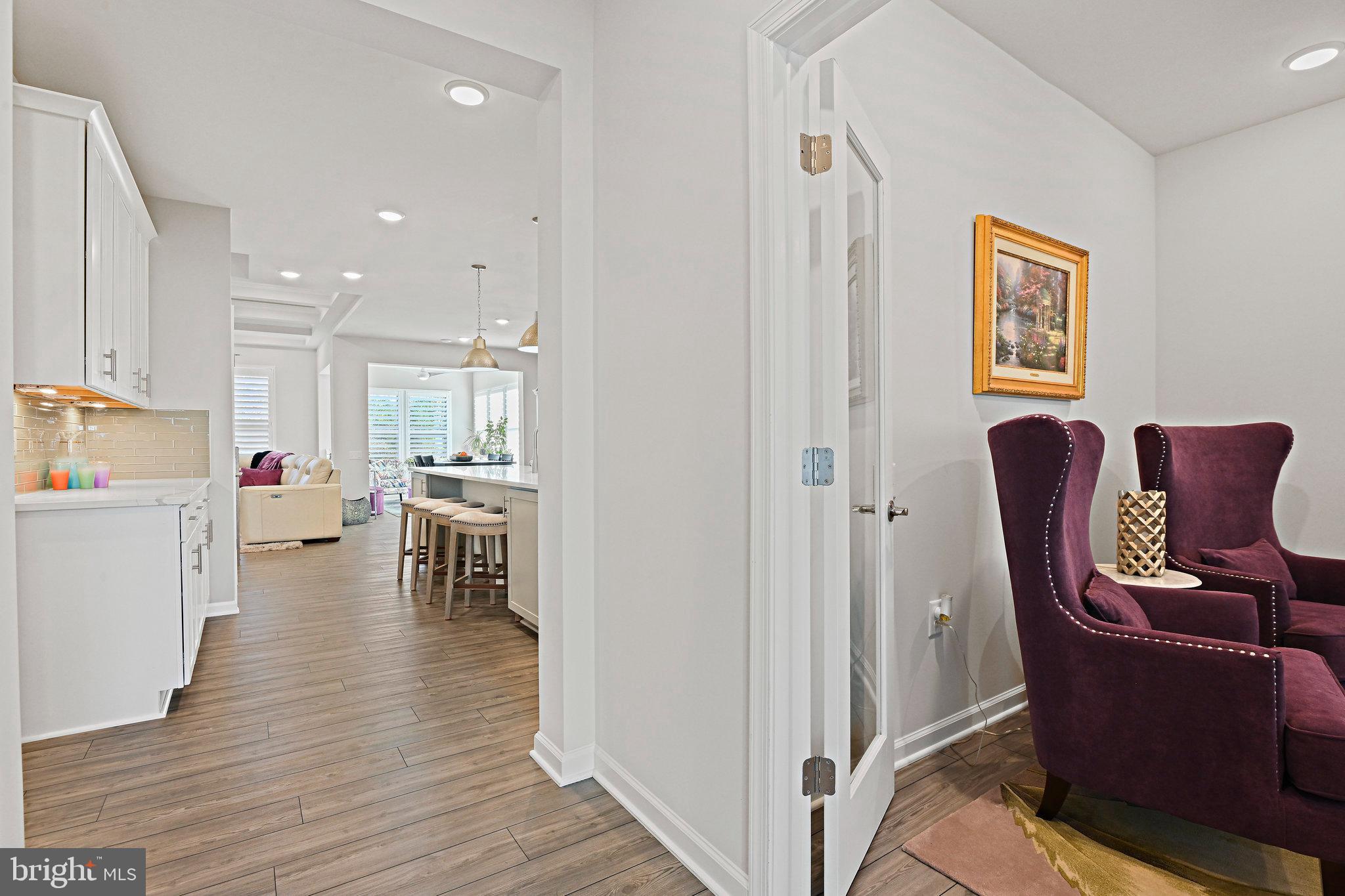 15788 Gardenia Rdg Way Haymarket, VA 20169 - Photo 7 of 50 a living room with furniture and a dining table with wooden floor