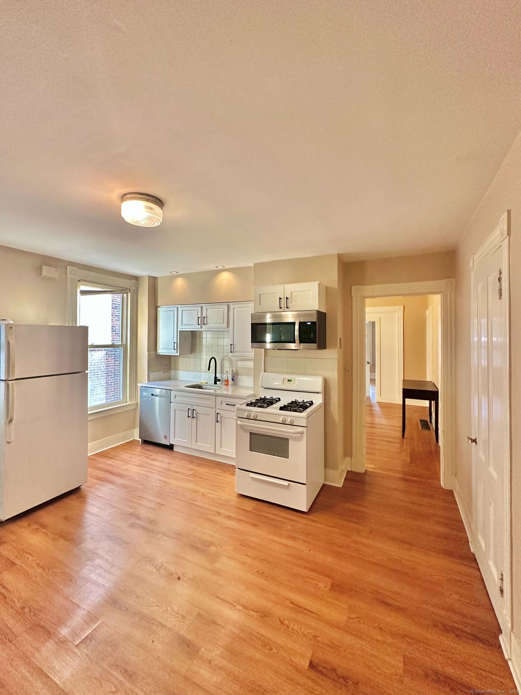 751 Orange Street, Unit 1 New Haven, CT 06511 - Photo 11 of 19 a large kitchen with stainless steel appliances granite countertop a large counter top and a stove top oven
