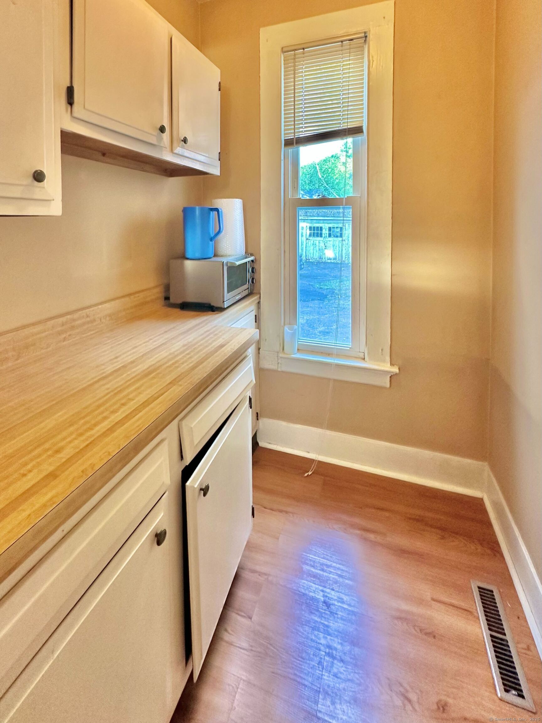 751 Orange Street, Unit 1 New Haven, CT 06511 - Photo 15 of 19 a view of a kitchen with wooden floor and cabinets