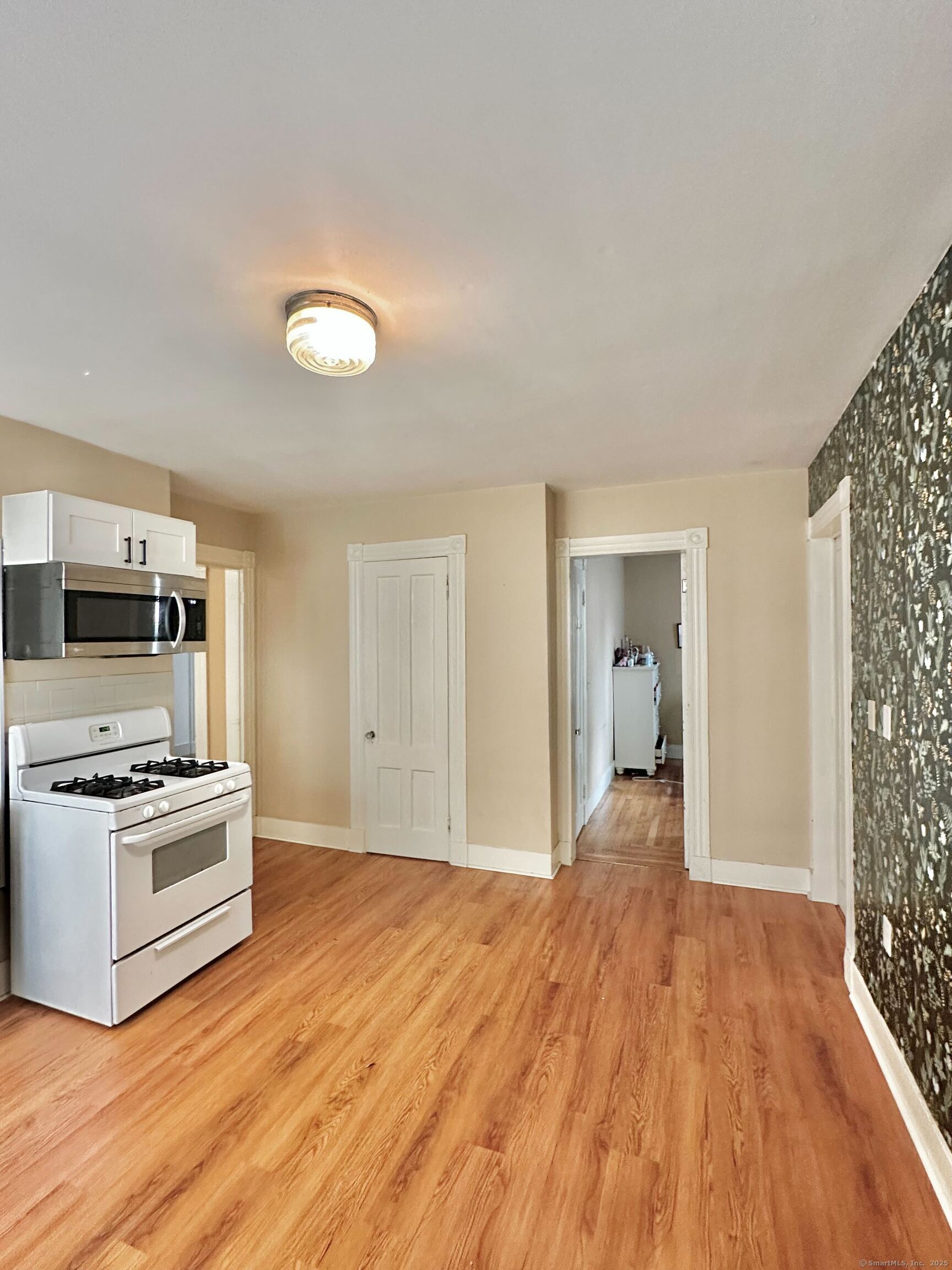 751 Orange Street, Unit 1 New Haven, CT 06511 - Photo 17 of 19 a view of a kitchen with wooden floor electronic appliances and furniture