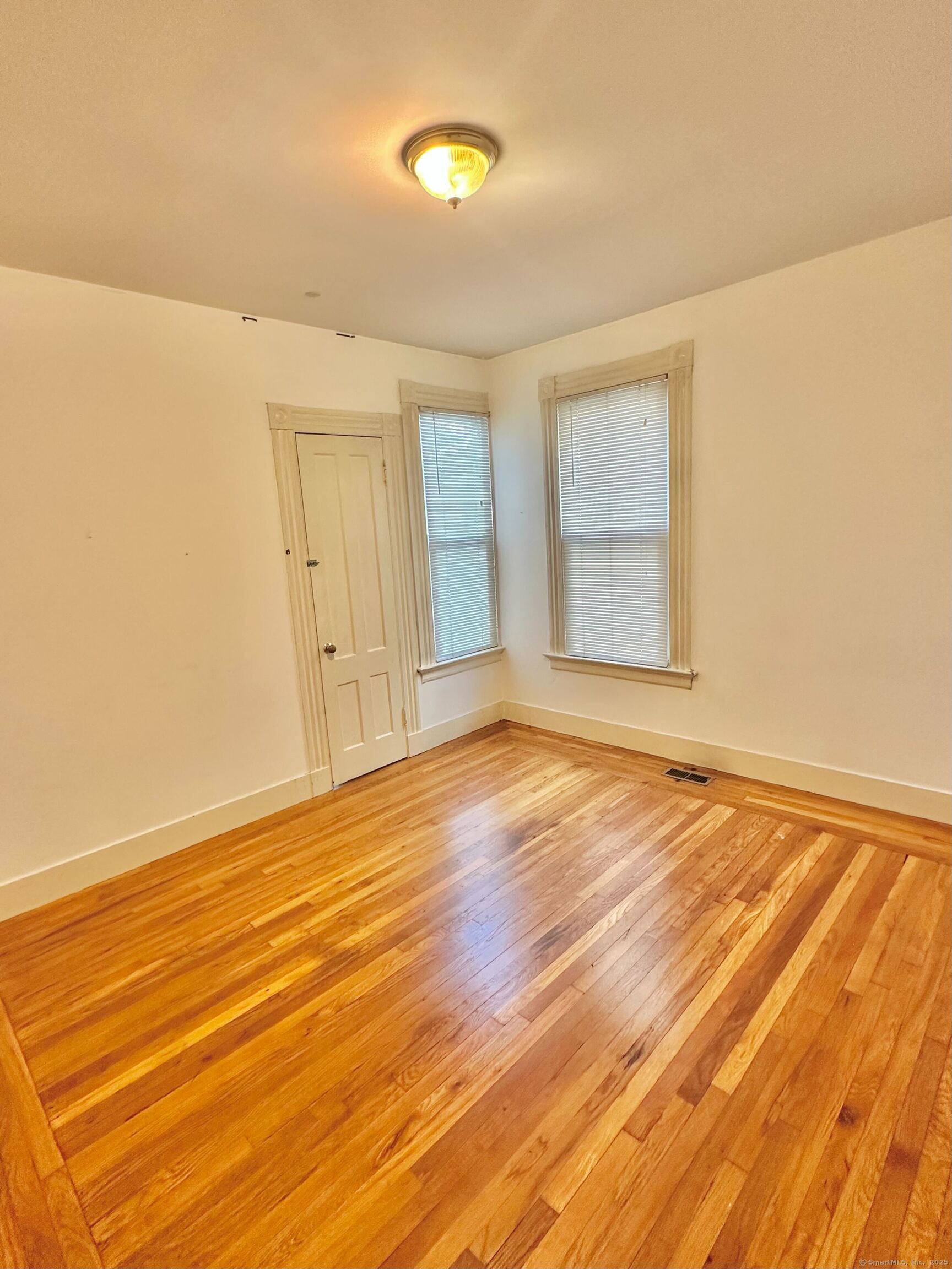 751 Orange Street, Unit 1 New Haven, CT 06511 - Photo 3 of 19 a view of an empty room with wooden floor and a window