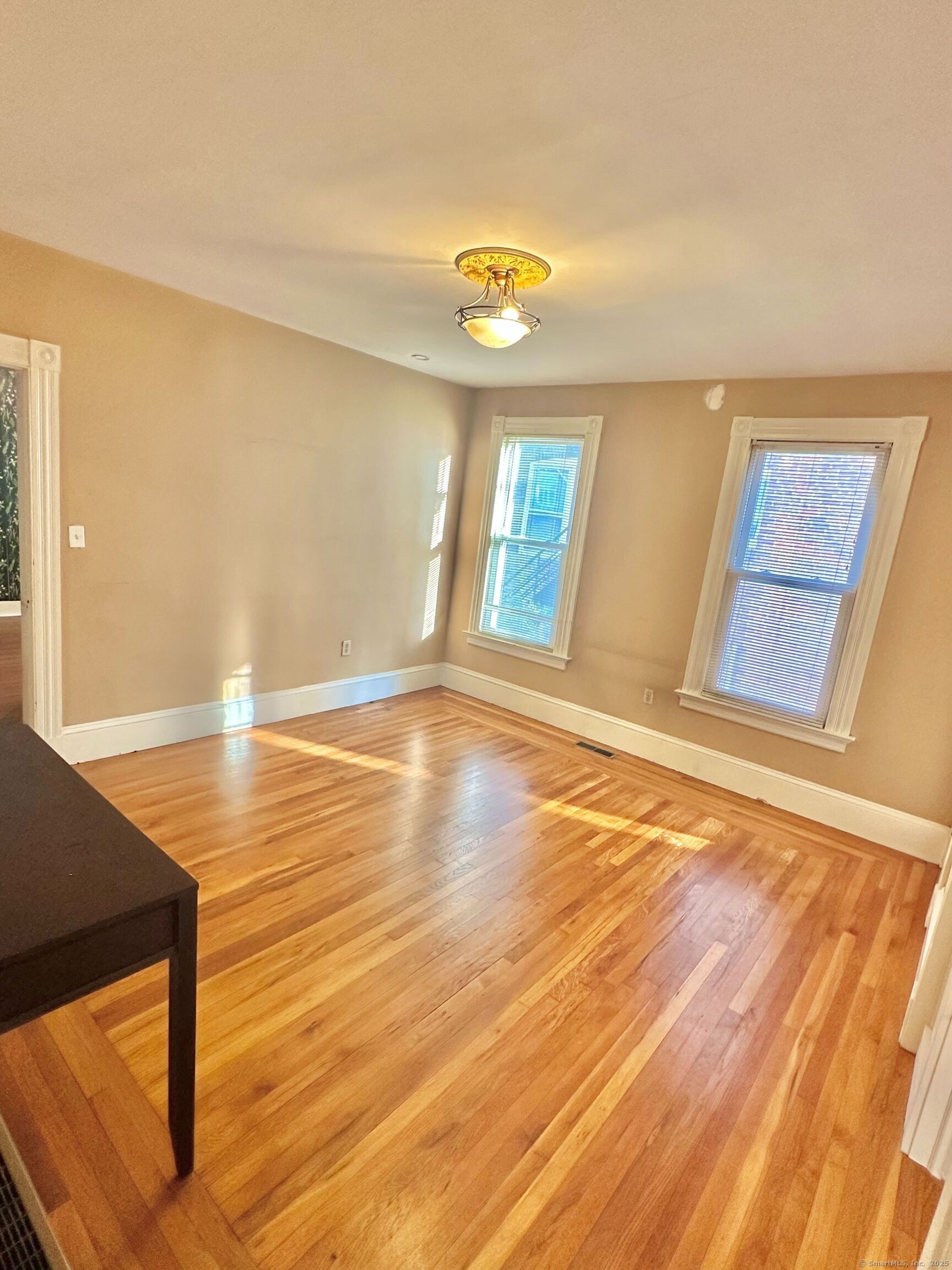 751 Orange Street, Unit 1 New Haven, CT 06511 - Photo 5 of 19 a view of an empty room with window and wooden floor