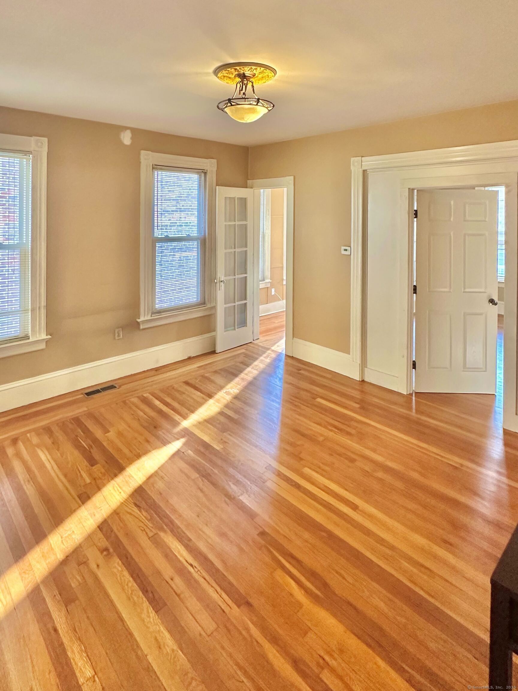 751 Orange Street, Unit 1 New Haven, CT 06511 - Photo 6 of 19 a view of an empty room with wooden floor and a window