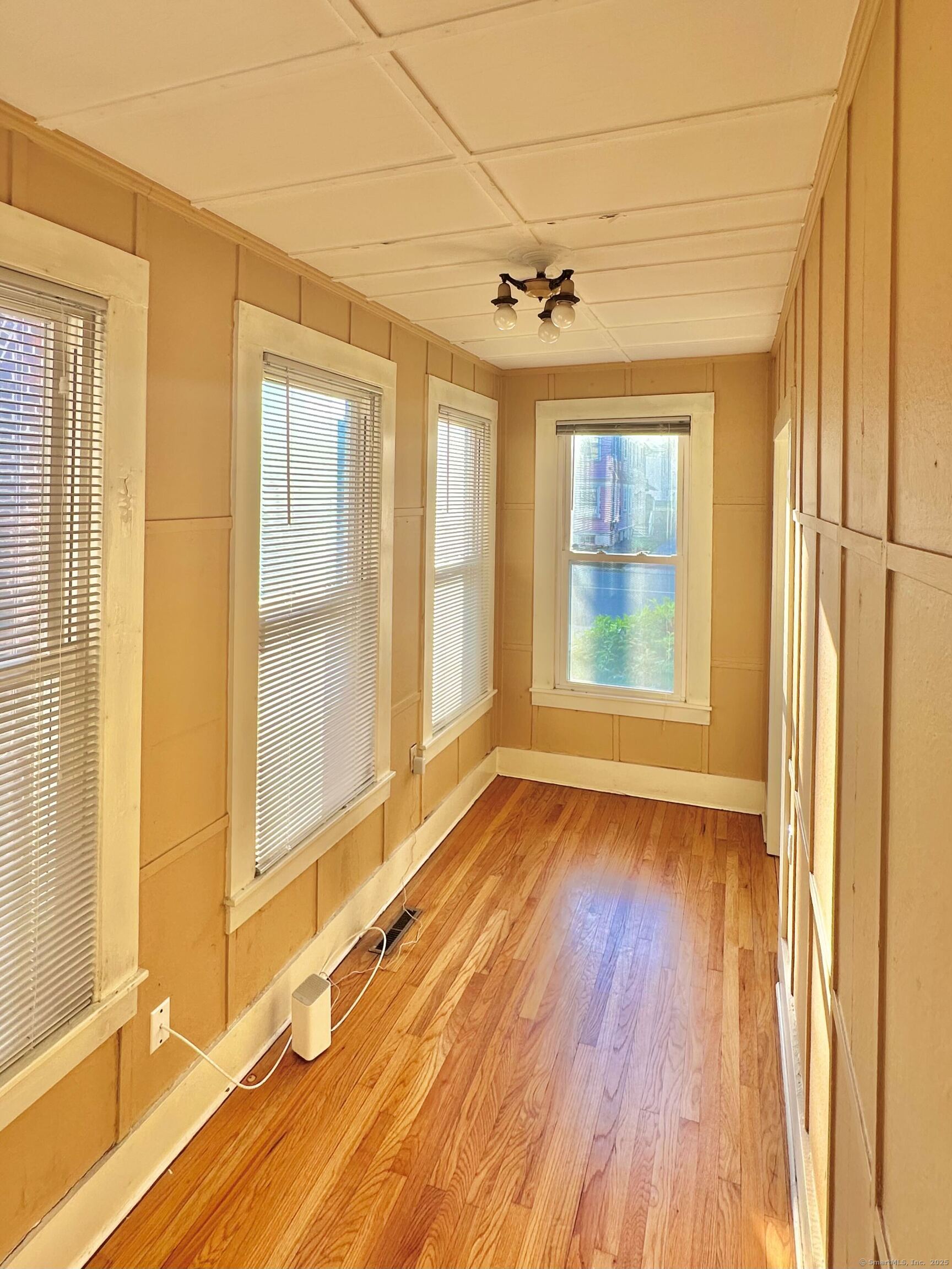 751 Orange Street, Unit 1 New Haven, CT 06511 - Photo 7 of 19 a view of an empty room with wooden floor and a window