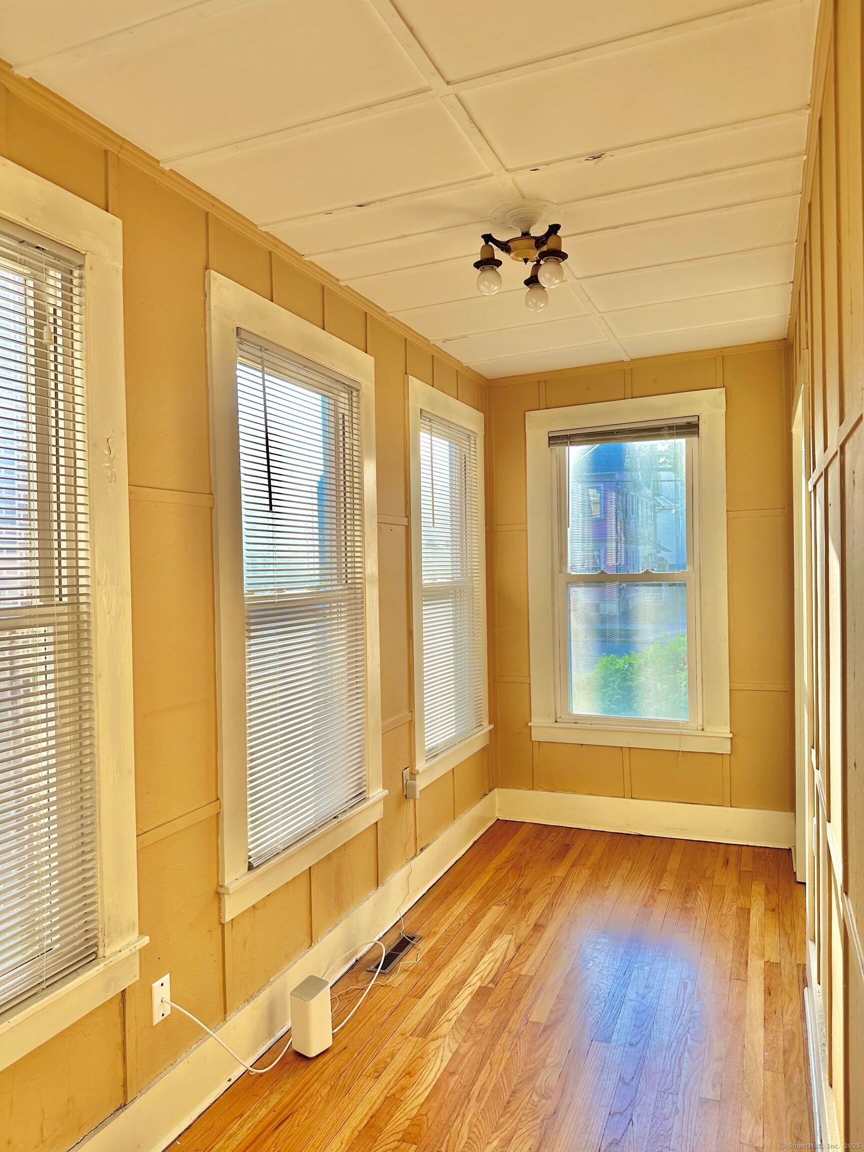 751 Orange Street, Unit 1 New Haven, CT 06511 - Photo 8 of 19 an empty room with wooden floor and windows