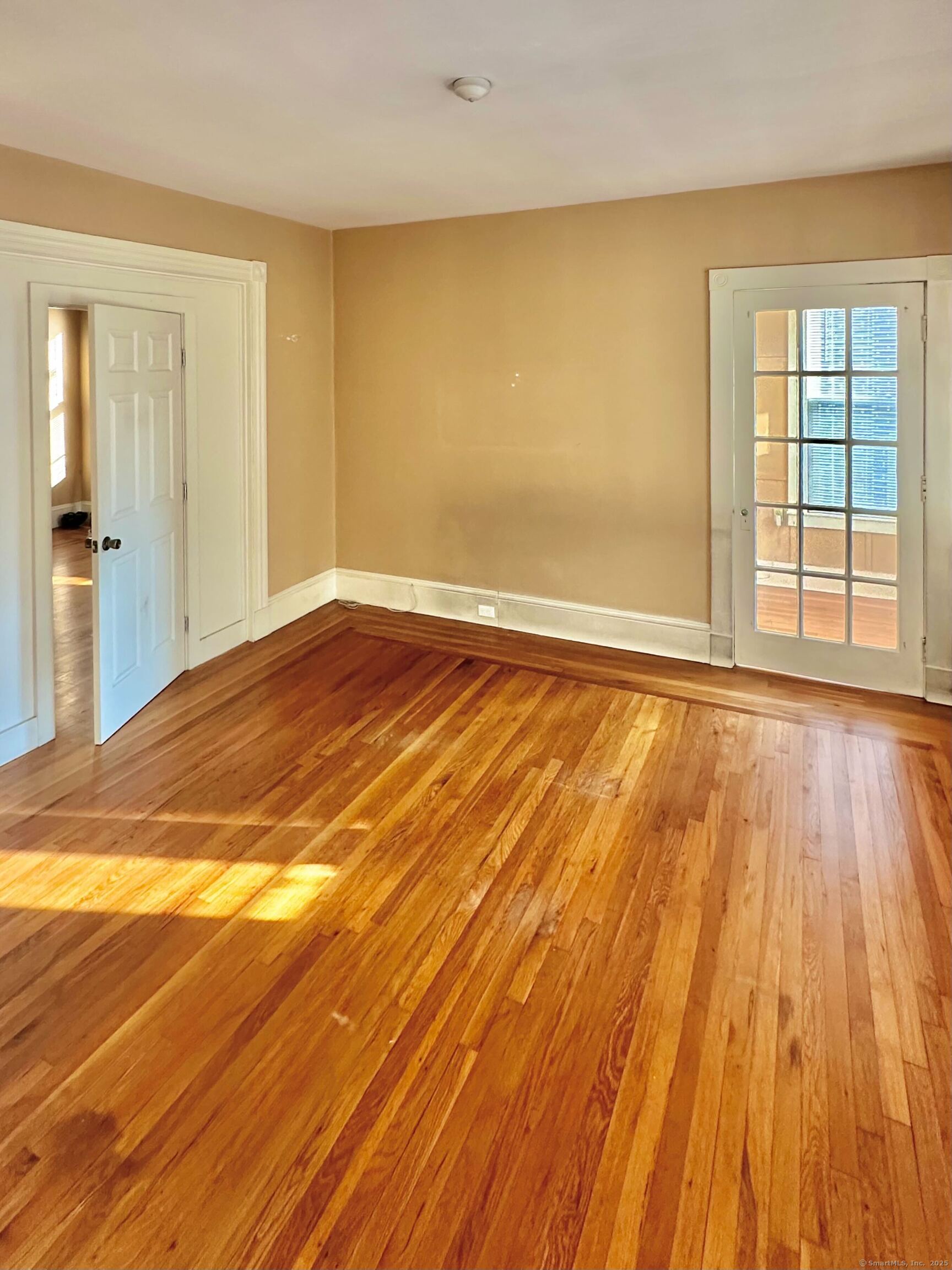 751 Orange Street, Unit 1 New Haven, CT 06511 - Photo 10 of 19 a view of an empty room with wooden floor and a window