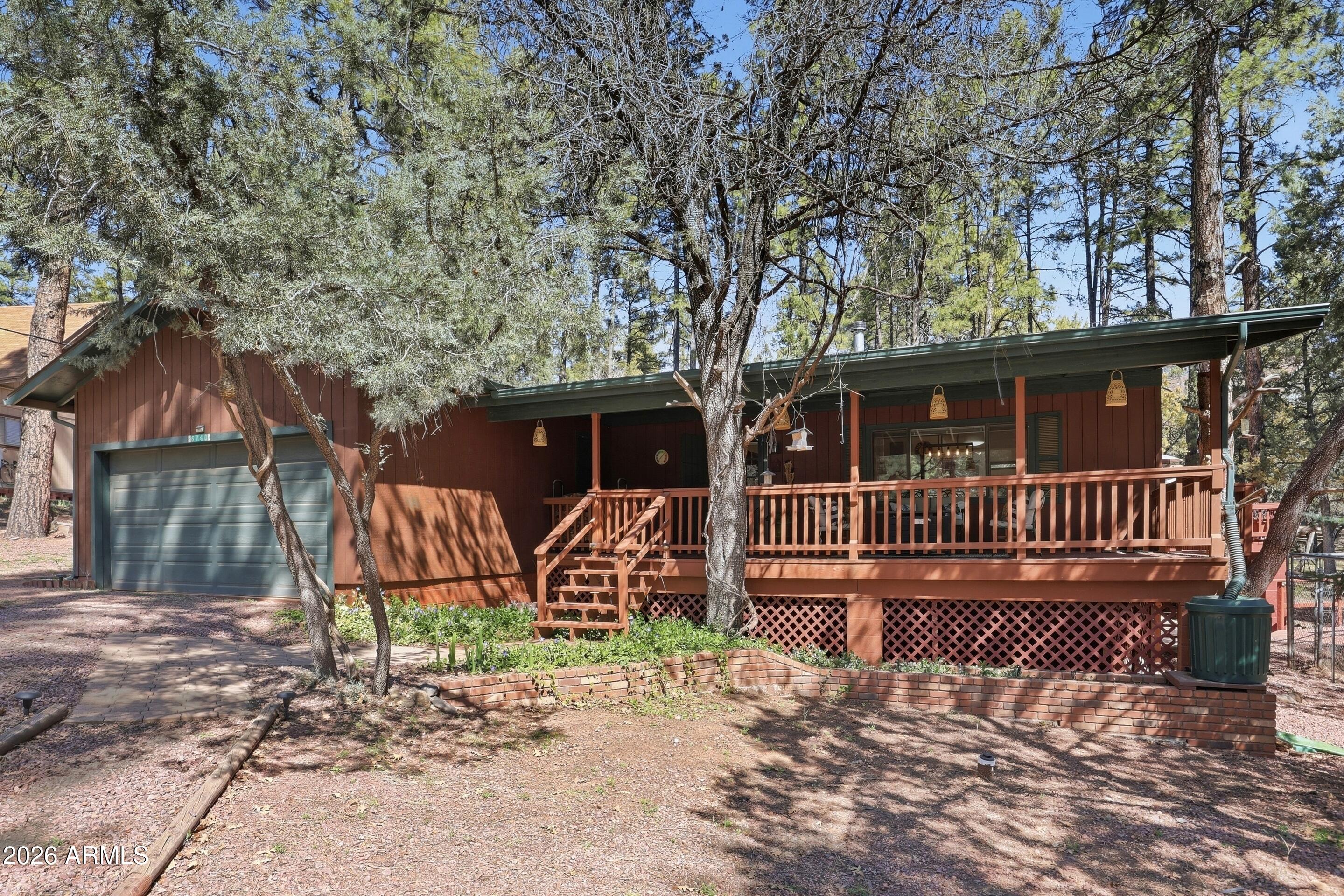 6740 Ridge Road Pine, AZ 85544 - Photo 2 of 35 a front view of a house with garden