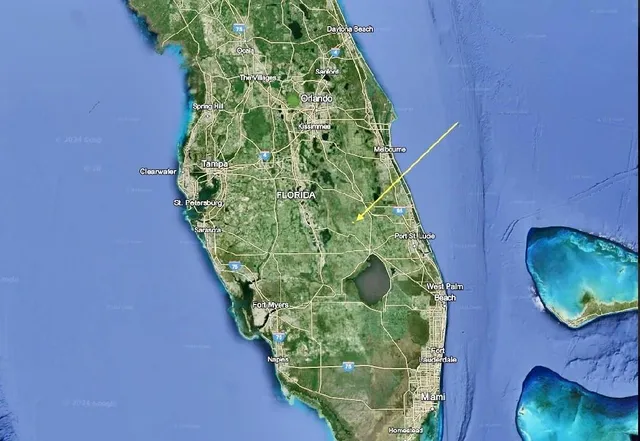 a bed with white sheets and pillows on it