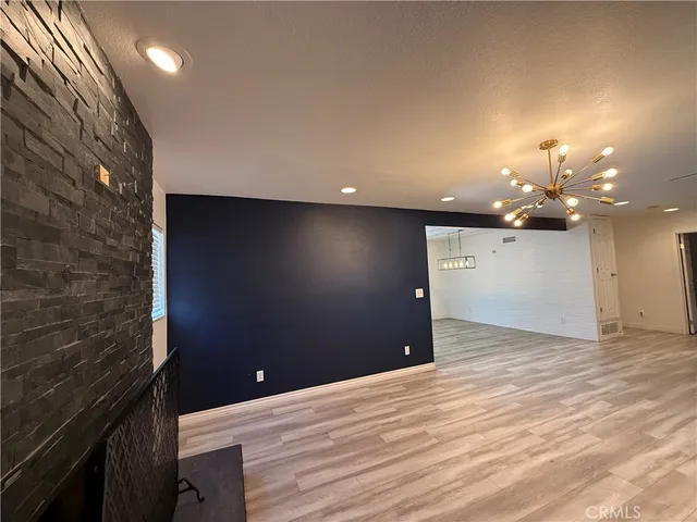 a kitchen with wooden floors and refrigerator