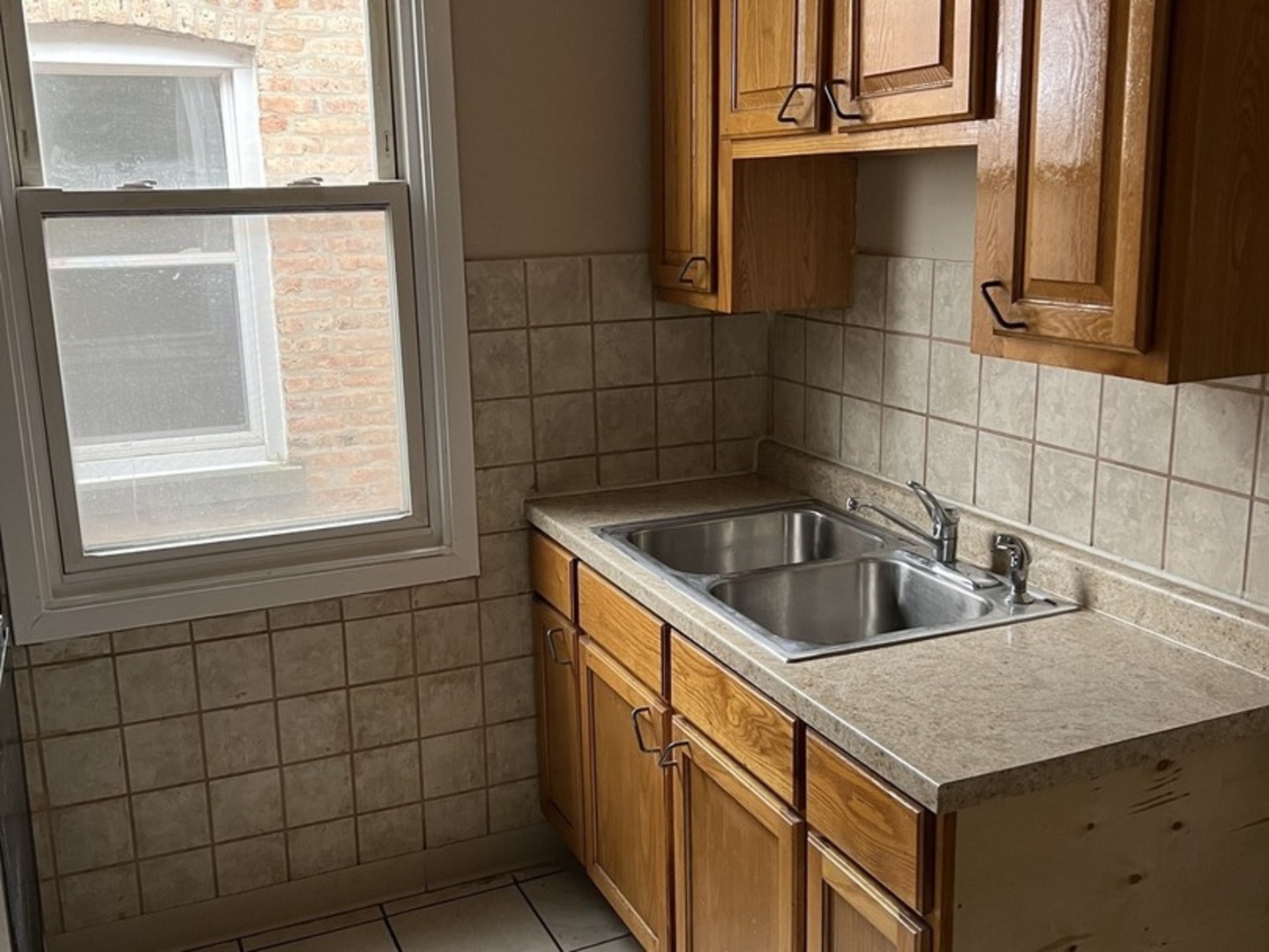 Undisclosed Address Chicago, IL 60624 - Photo 11 of 16 a kitchen with a sink a window and washer