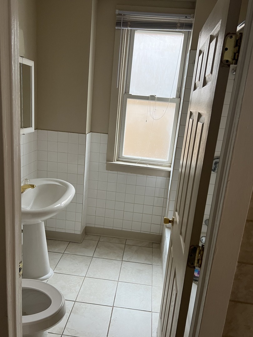 Undisclosed Address Chicago, IL 60624 - Photo 14 of 16 a bathroom with a sink and toilet