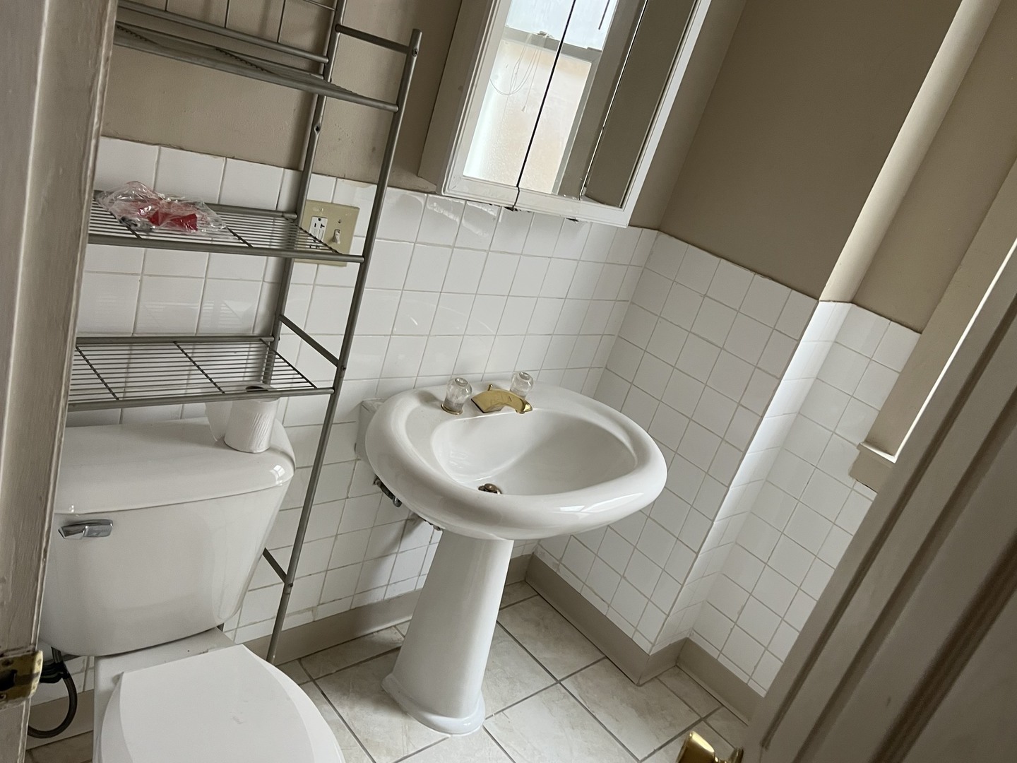 Undisclosed Address Chicago, IL 60624 - Photo 15 of 16 a bathroom with a sink toilet and shower