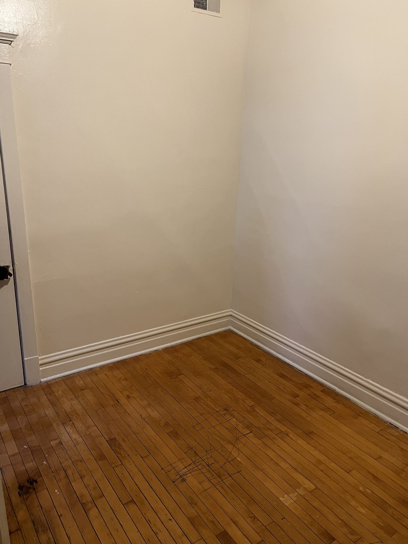 Undisclosed Address Chicago, IL 60624 - Photo 9 of 16 a view of an empty room with wooden floor
