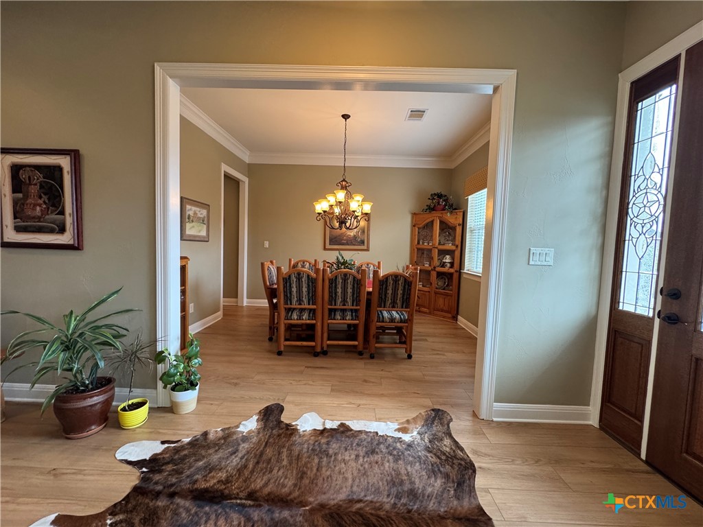 2306 Arroyo Grande Leander, TX 78641 - Photo 13 of 44 a living room with furniture and a chandelier