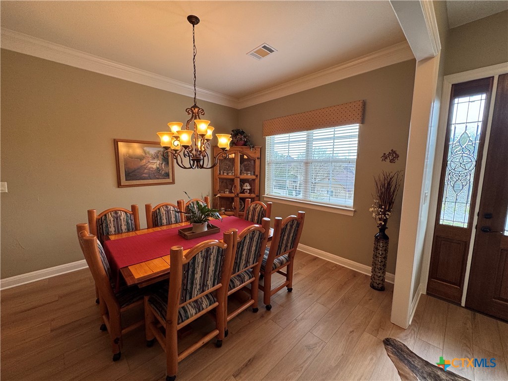 2306 Arroyo Grande Leander, TX 78641 - Photo 14 of 44 a view of a dining room with furniture window and wooden floor
