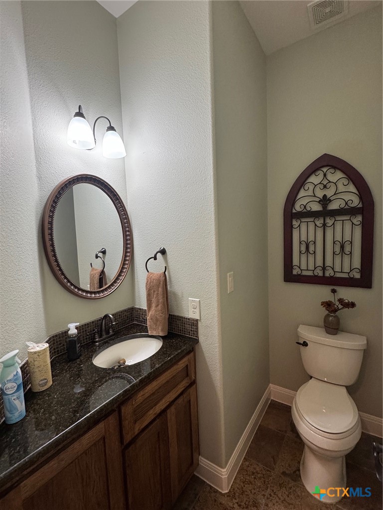 2306 Arroyo Grande Leander, TX 78641 - Photo 17 of 44 a bathroom with a toilet a sink and a mirror