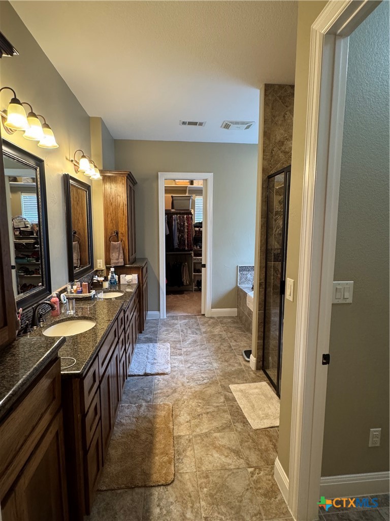 2306 Arroyo Grande Leander, TX 78641 - Photo 20 of 44 a lobby with a sink and a mirror