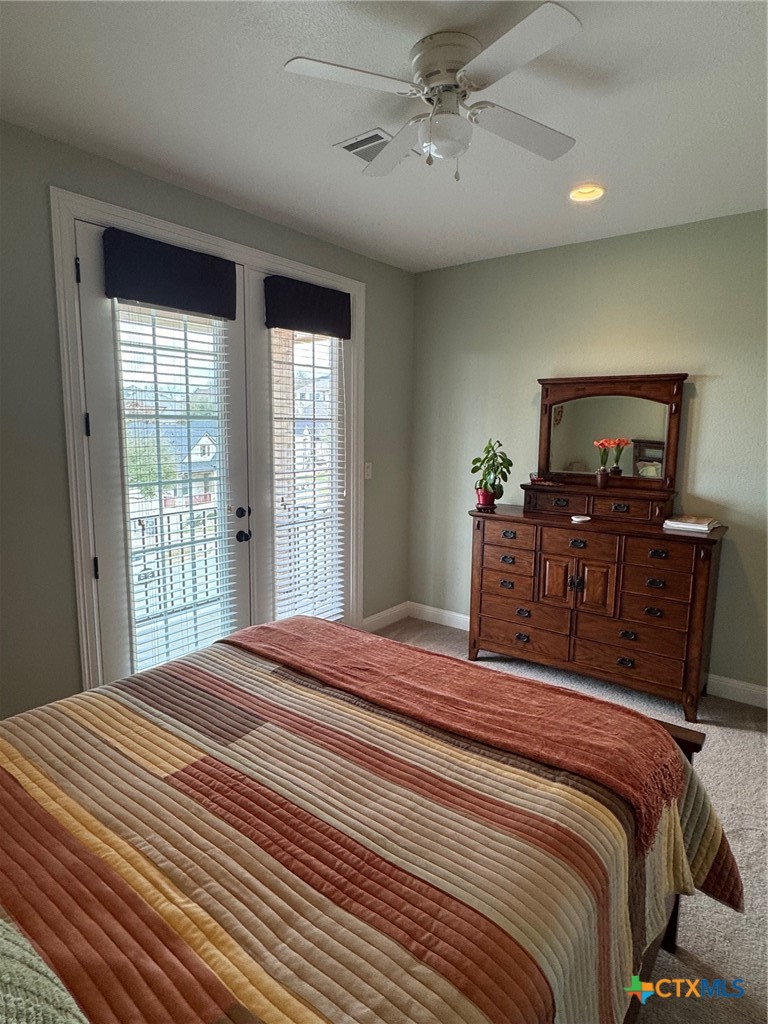 2306 Arroyo Grande Leander, TX 78641 - Photo 30 of 44 a bedroom with a bed and a flat tv screen on dresser