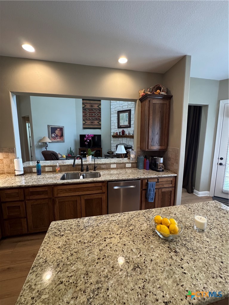 2306 Arroyo Grande Leander, TX 78641 - Photo 4 of 44 a kitchen with stainless steel appliances granite countertop a sink and cabinets
