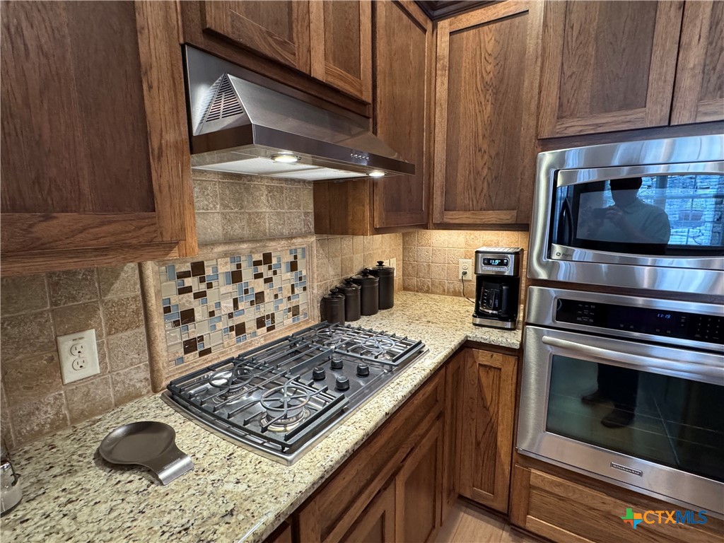 2306 Arroyo Grande Leander, TX 78641 - Photo 5 of 44 a kitchen with a stove a microwave and cabinets