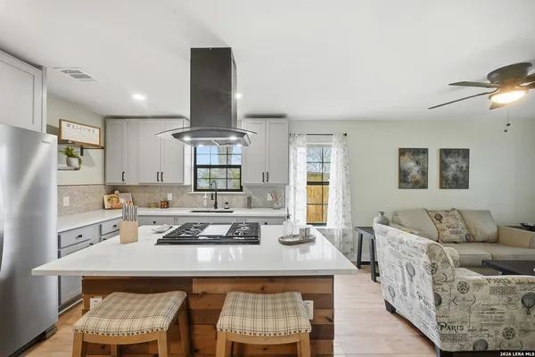 a kitchen with stainless steel appliances granite countertop sink stove and refrigerator