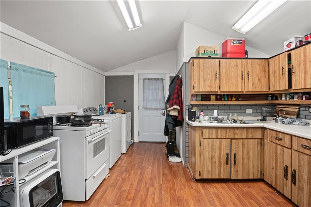 518 West Penn Street Butler, PA 16001 - Photo 5 of 14 a kitchen with a stove a sink and a refrigerator