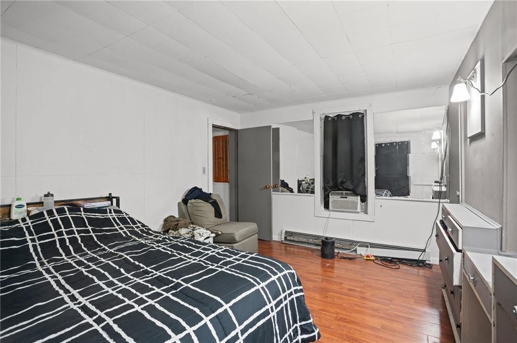 518 West Penn Street Butler, PA 16001 - Photo 7 of 14 a bedroom with a bed and wooden floor