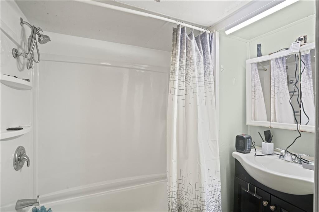 518 West Penn Street Butler, PA 16001 - Photo 9 of 14 a bathroom with a sink a mirror and a shower