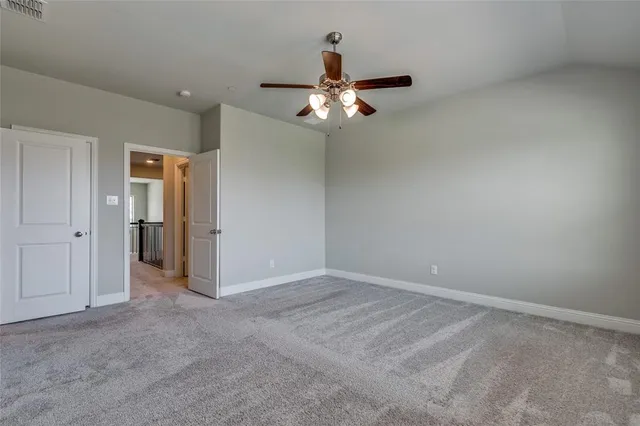 an empty room and chandelier fan