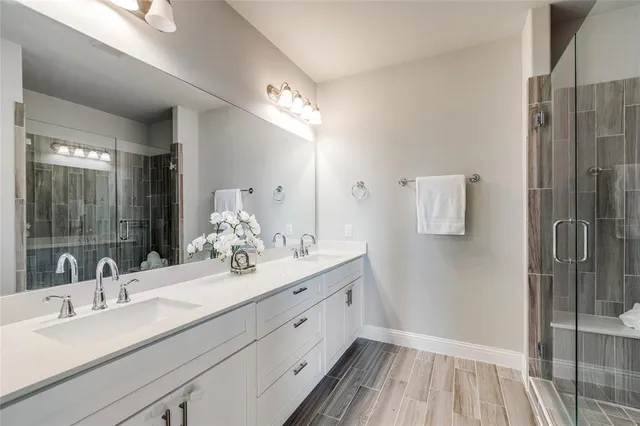 a bathroom with a double vanity sink and mirror