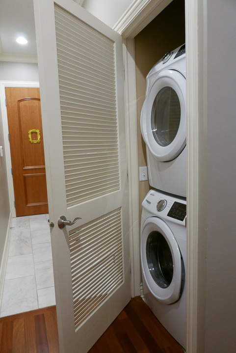 Undisclosed Address Chicago, IL 60607 - Photo 12 of 47 a view of a hallway with washer and dryer