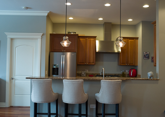 Undisclosed Address Chicago, IL 60607 - Photo 13 of 47 a kitchen with a table chairs refrigerator and microwave