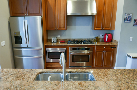Undisclosed Address Chicago, IL 60607 - Photo 19 of 47 a kitchen with stainless steel appliances granite countertop a refrigerator stove and sink