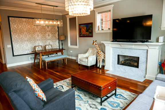 Undisclosed Address Chicago, IL 60607 - Photo 24 of 47 a living room with furniture a flat screen tv and a fireplace