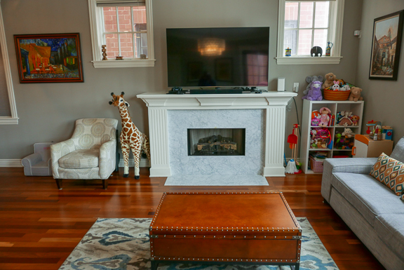 Undisclosed Address Chicago, IL 60607 - Photo 25 of 47 a living room with furniture a flat screen tv and a fireplace