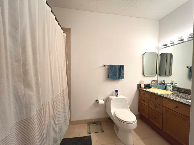 a bathroom with a toilet a sink and a mirror