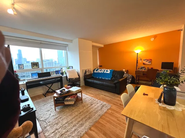a living room with furniture and a floor to ceiling window