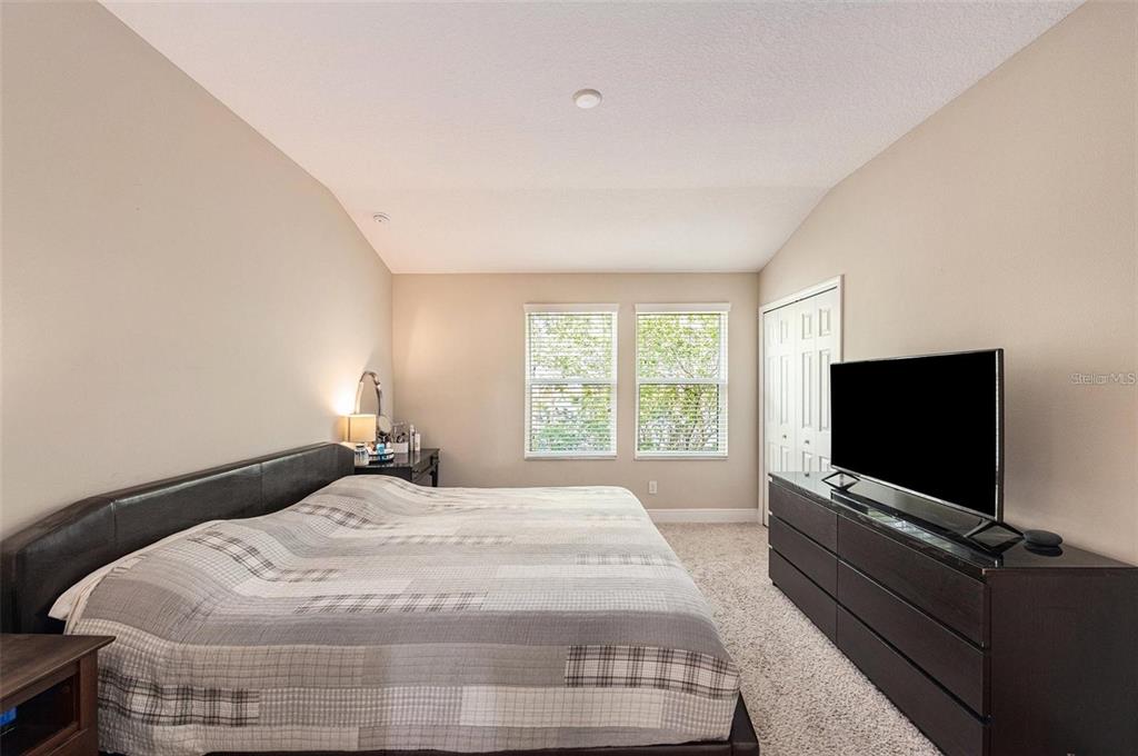 9152 Fox Sparrow Road Tampa, FL 33626 - Photo 15 of 32 a bedroom with a bed and a flat screen tv