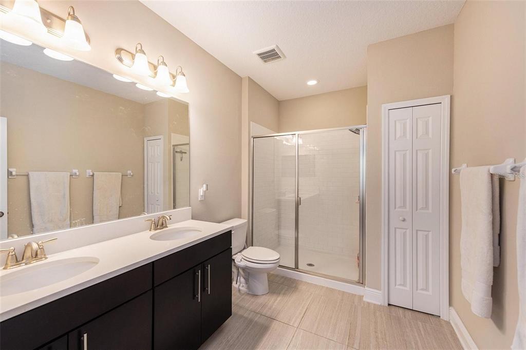 9152 Fox Sparrow Road Tampa, FL 33626 - Photo 16 of 32 a bathroom with a double vanity sink mirror and toilet