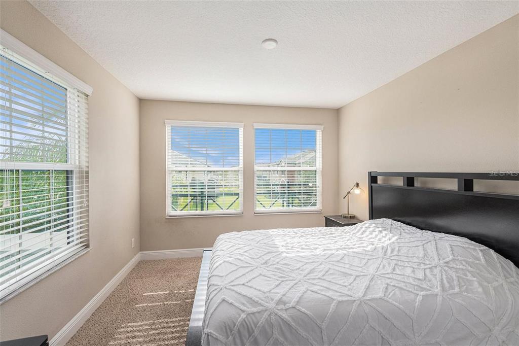 9152 Fox Sparrow Road Tampa, FL 33626 - Photo 17 of 32 a bedroom with a bed and next to a window